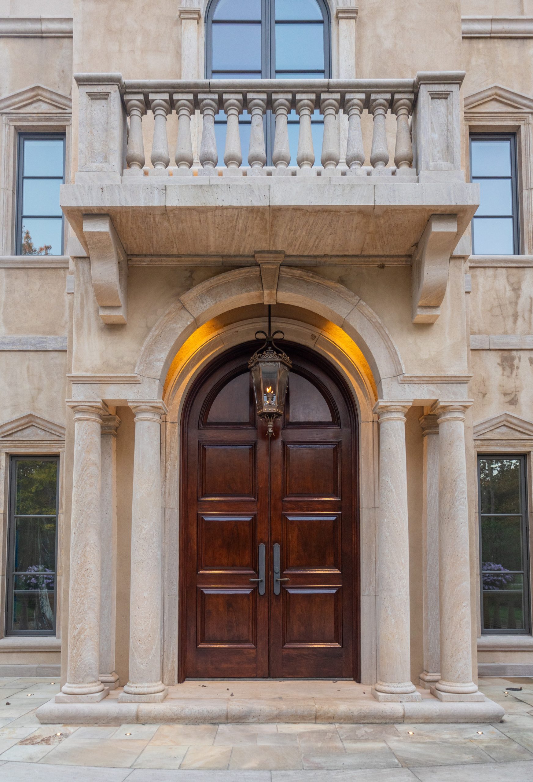 house painter working on a Large wood front door refinished and stained service