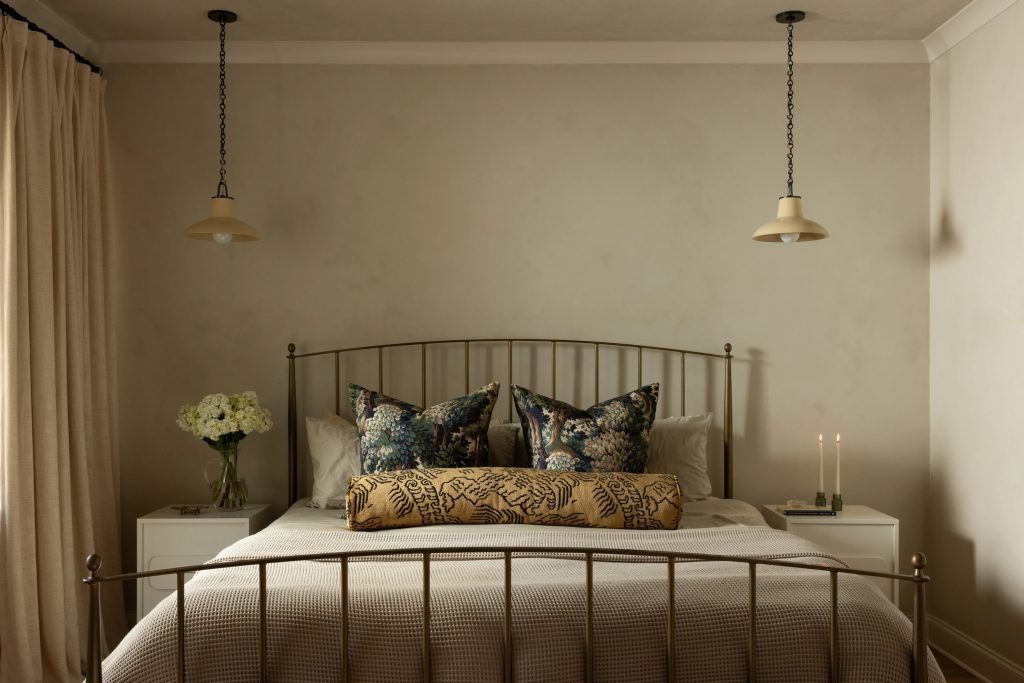 Limewash bedroom primary suite with JH Lime Wall Paint No. 107 greige walls brass bed and soft pendant lighting