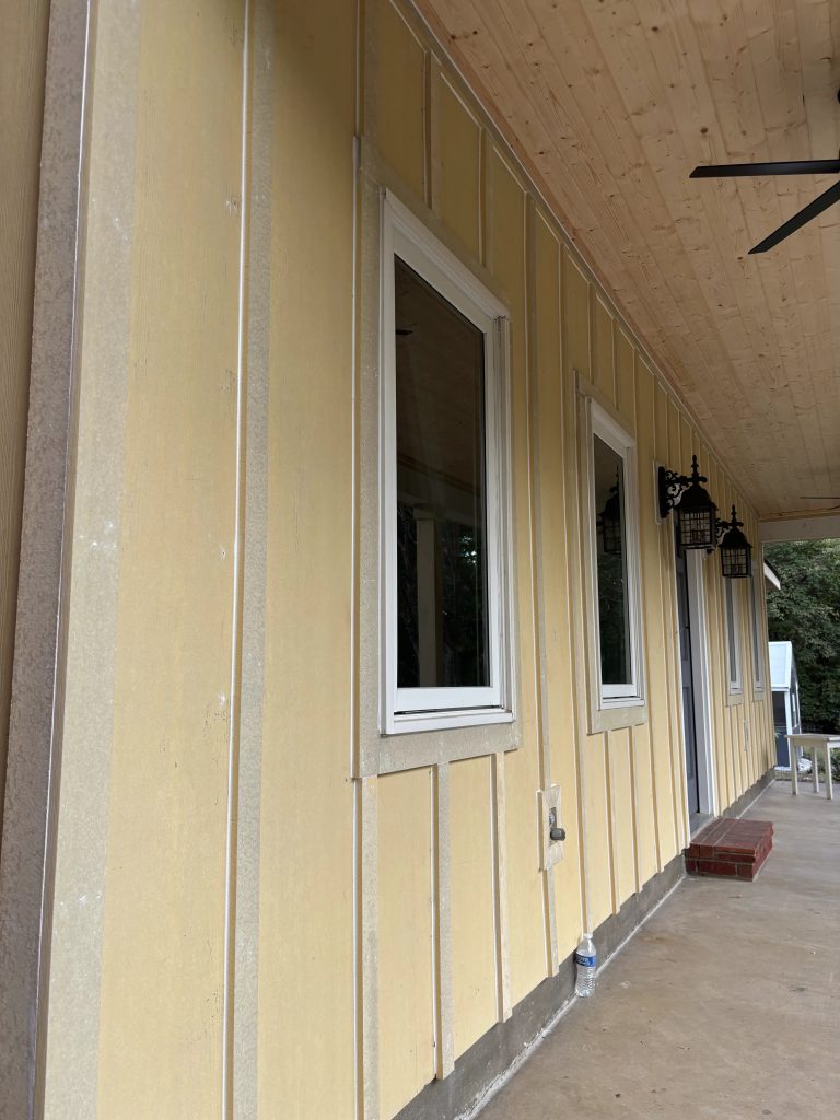 Caulked seams on primed Hardie siding before the finish coat